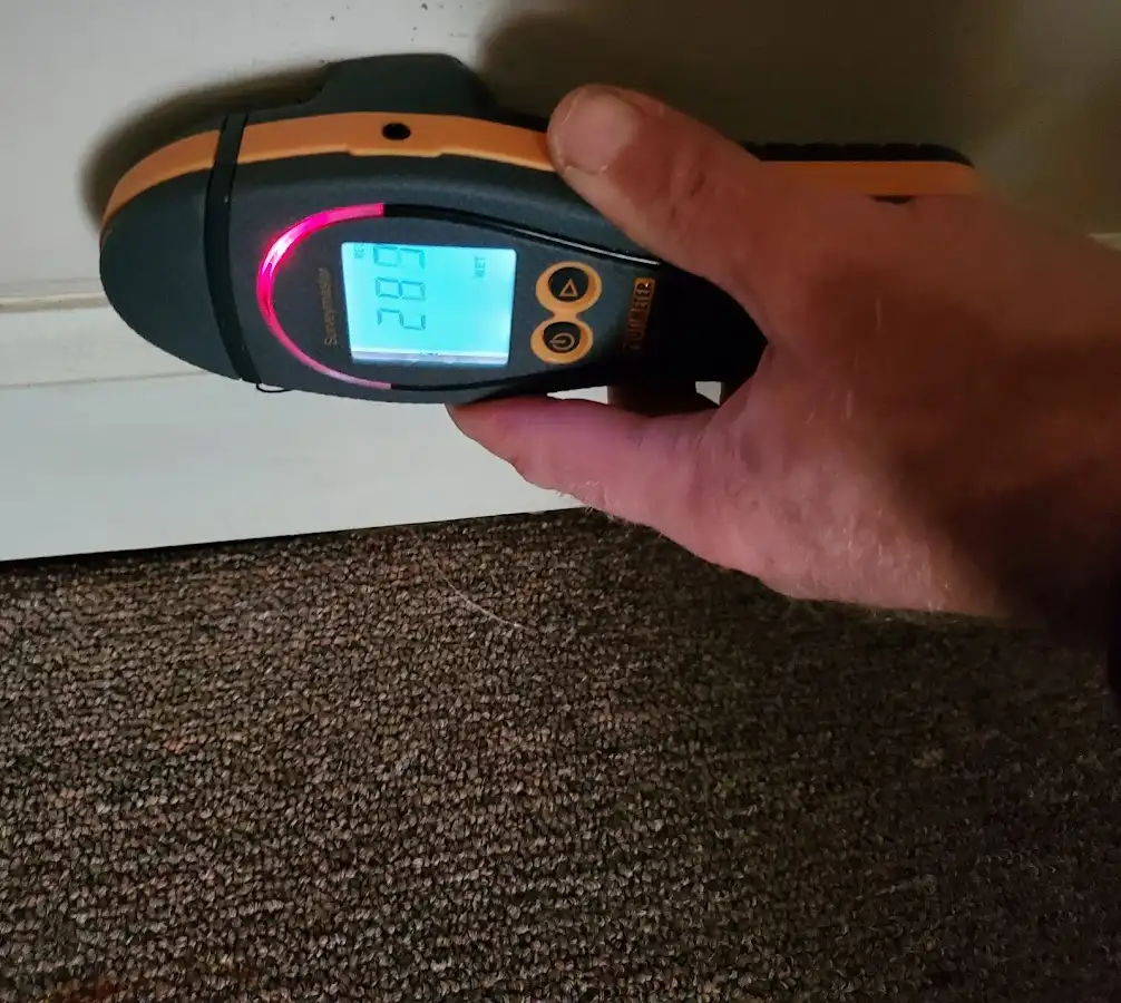 Moisture detection at baseboard during Storm Damage Restoration in Central